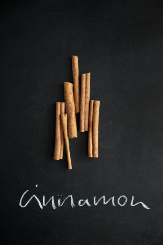 cinnamon sticks on chalkboard with chalk writing